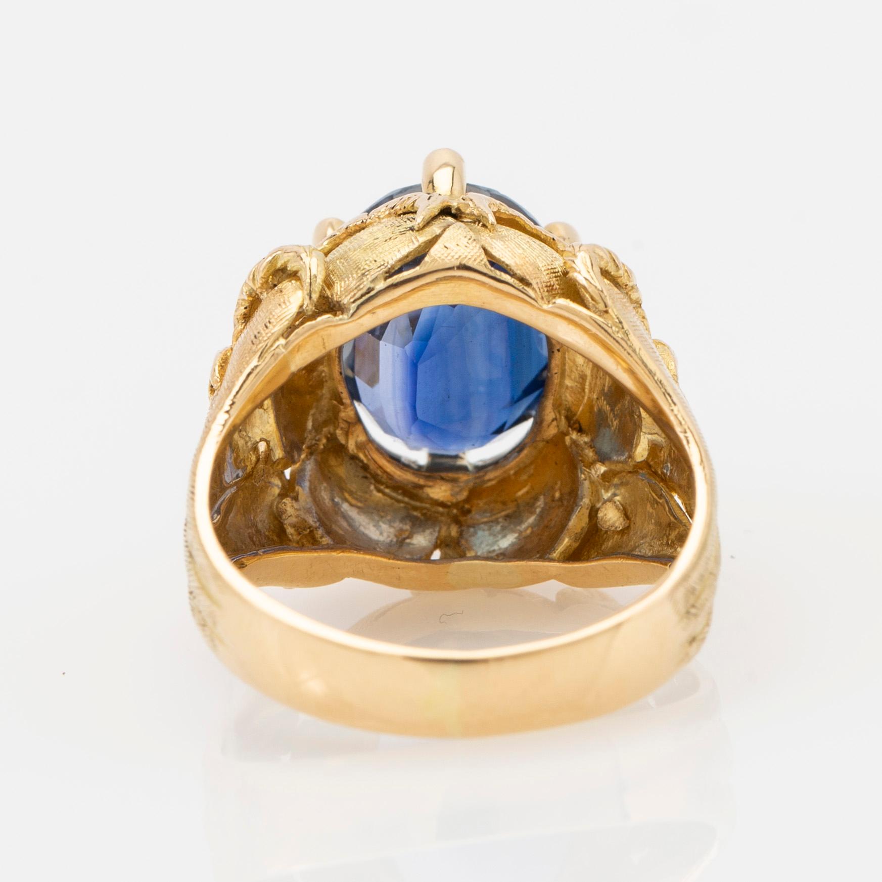 Ring, 18k gold with blue stone, possibly sapphire.