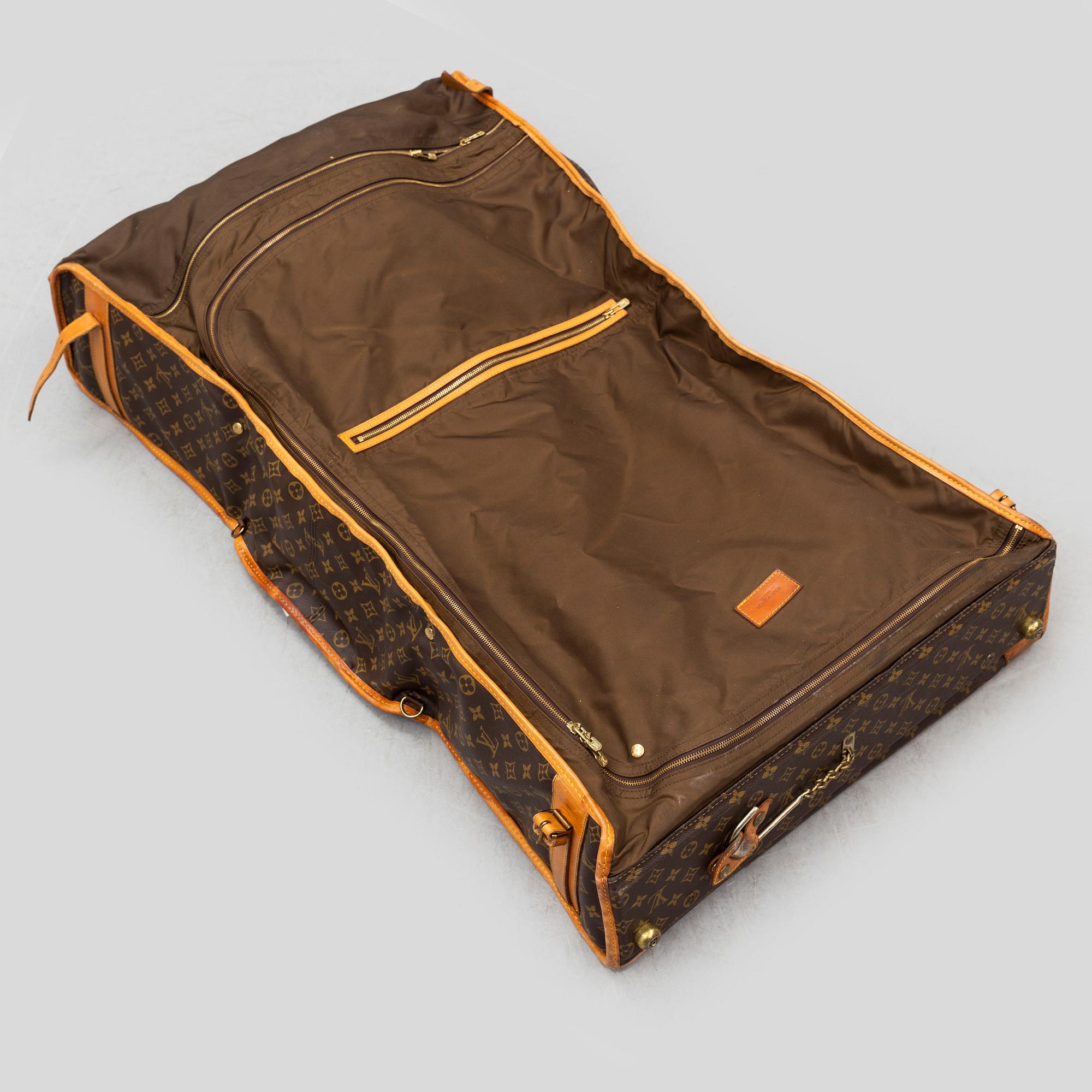 LOUIS VUITTON, a monogram canvas garment bag.