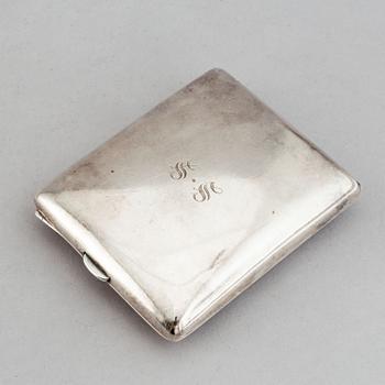 A silver travel alarm clock, makr of Hasset & Harper Ltd, Birmingham 1921.