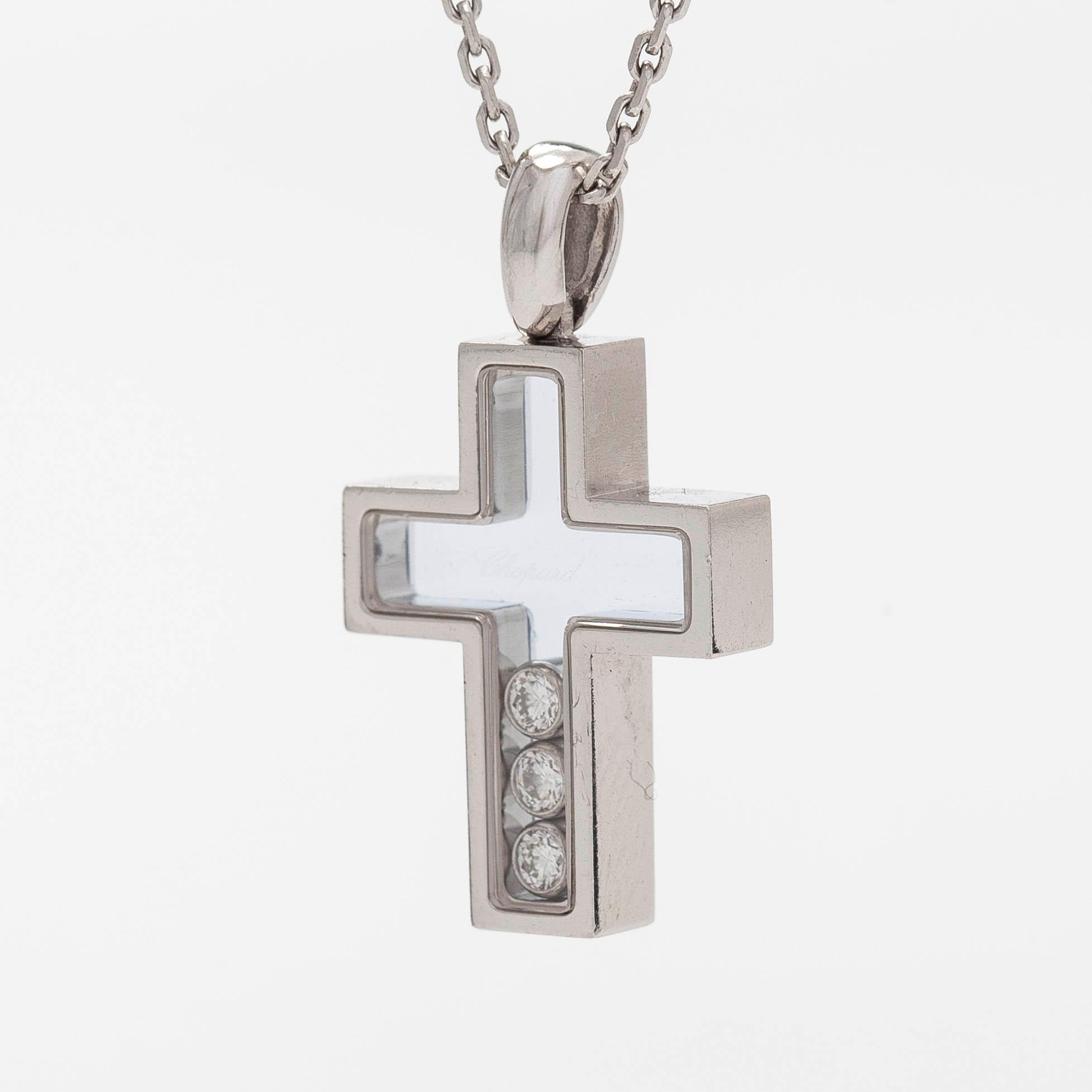 Chopard, an 18K whitegold 'Happy Diamonds" cross necklace set with diamonds.