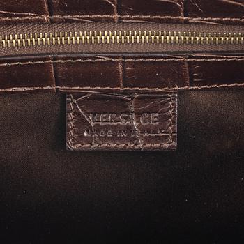 Versace, a bronze metallic leather handbag.