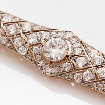 A platinum and 14K gold brooch set with an old-cut diamond weight ca 1.05 cts quality ca H si.