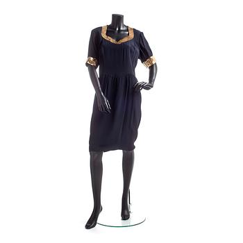 603. ESCADA, a black coctaildress with gold colored sequins.