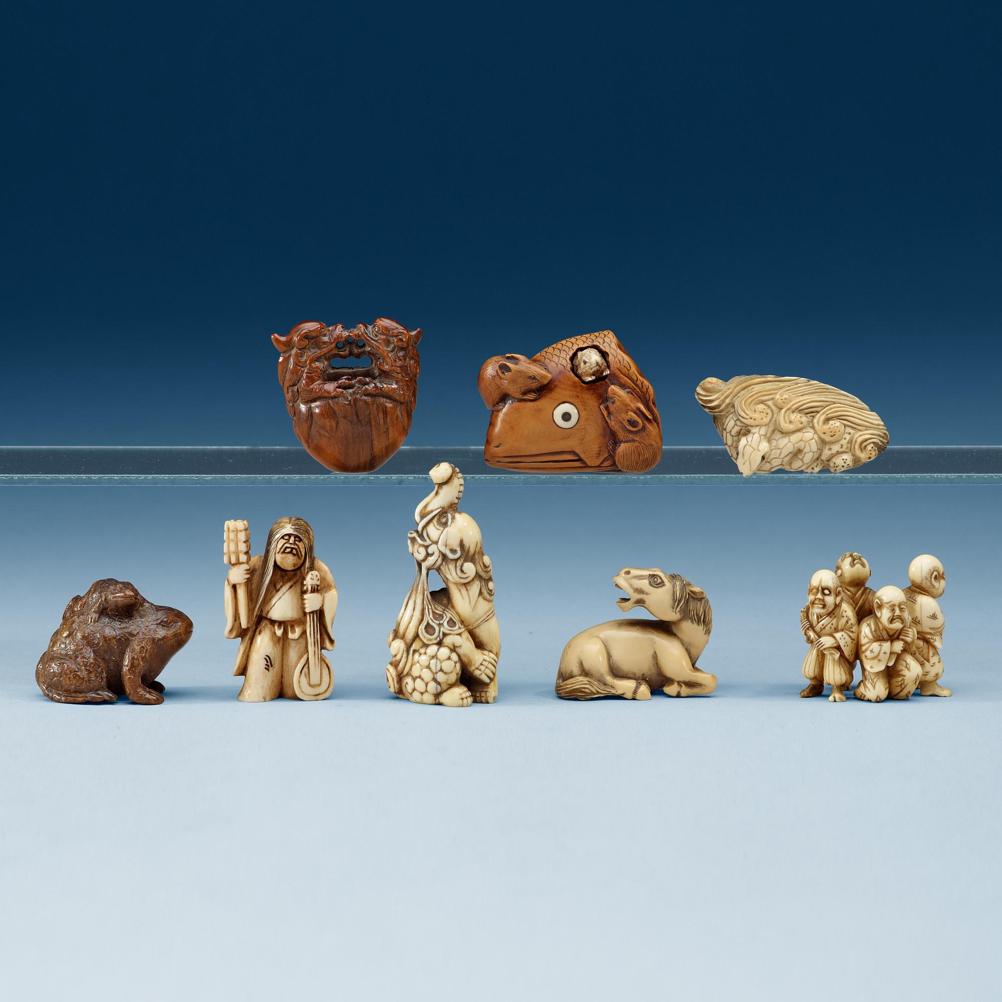 A group of eight wooden-, and bone netsukes, Japan, Meiji (1868-1912).