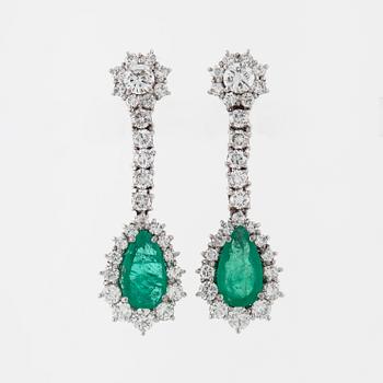 A pair of pear cut emerald and brilliant cut diamond earrings.