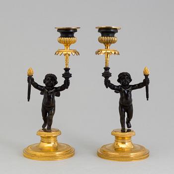 A pair of late 19th century, gilded bronze, Empire style, candle sticks.