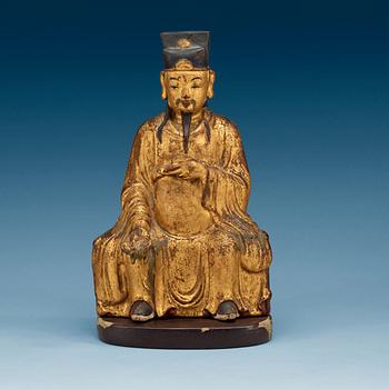 A gilt and lacquered wooden figure of a deity, Ming style.