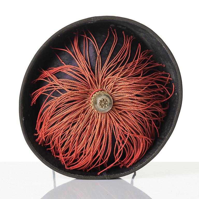 Two boxes with a mandarin's summer hat and black satin autumn hat and feather with six mandarin hat insignias.