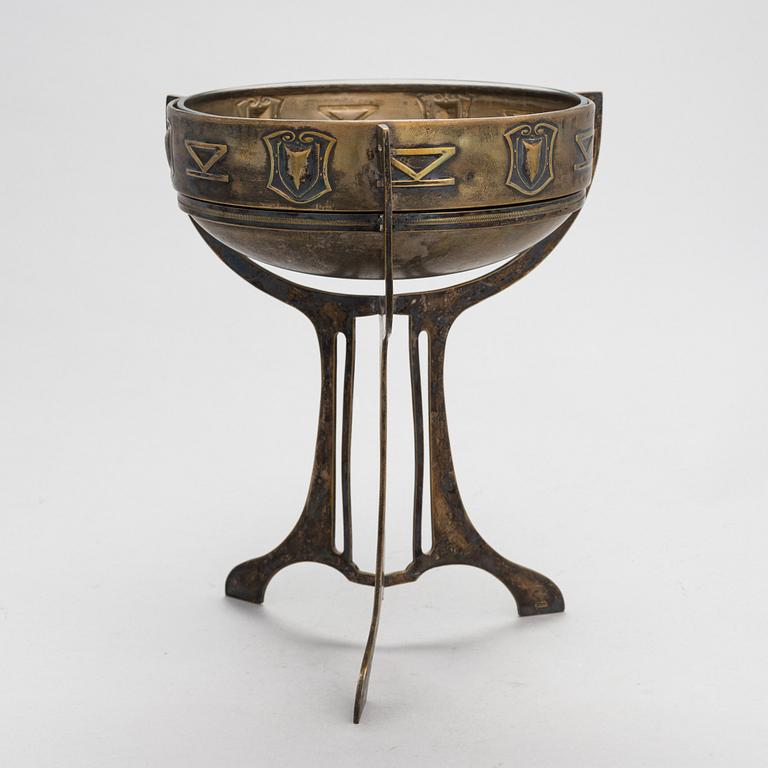 A early 20th-century Jugend Style brass bowl with glass liner.