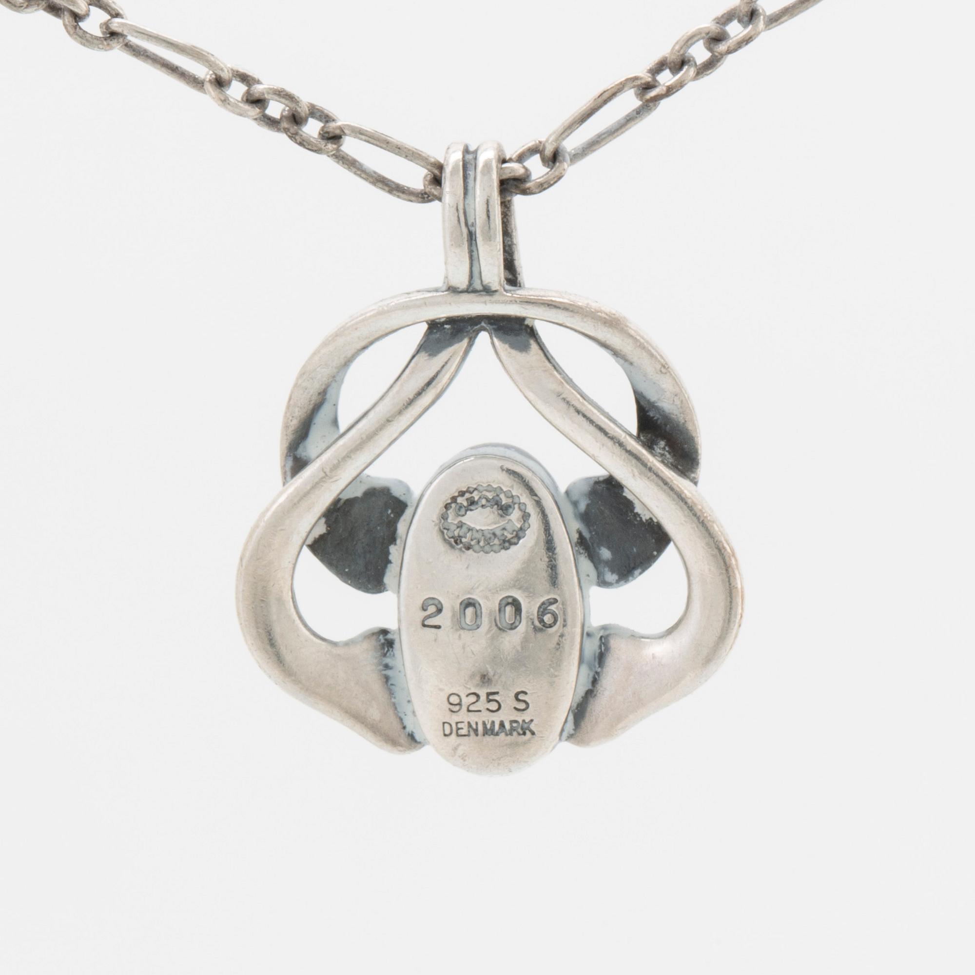 A silver and moonstone jewellery set consisting of necklace and earrings by Georg Jensen, jewellery of the year 2006.