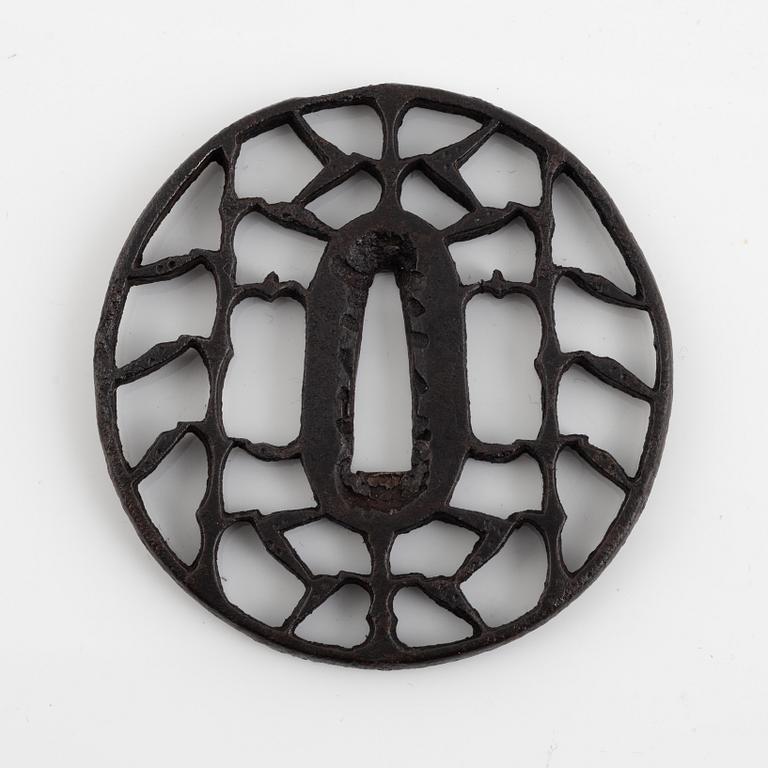 An iron open work, sukashi, Japanese tsuba, Edo (1603-1868). In a kiri box.