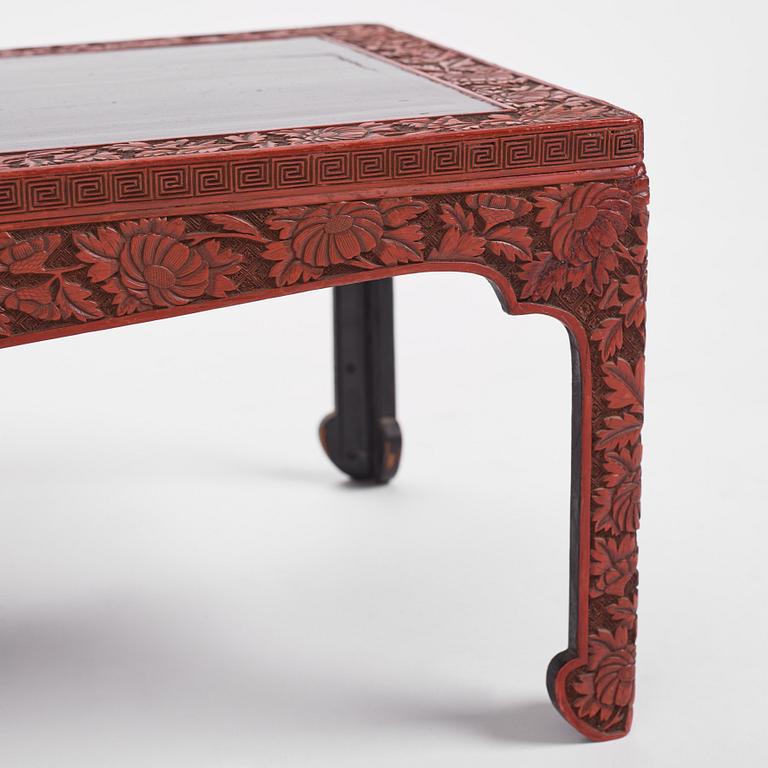 A carved lacquered table, early 20th Century.