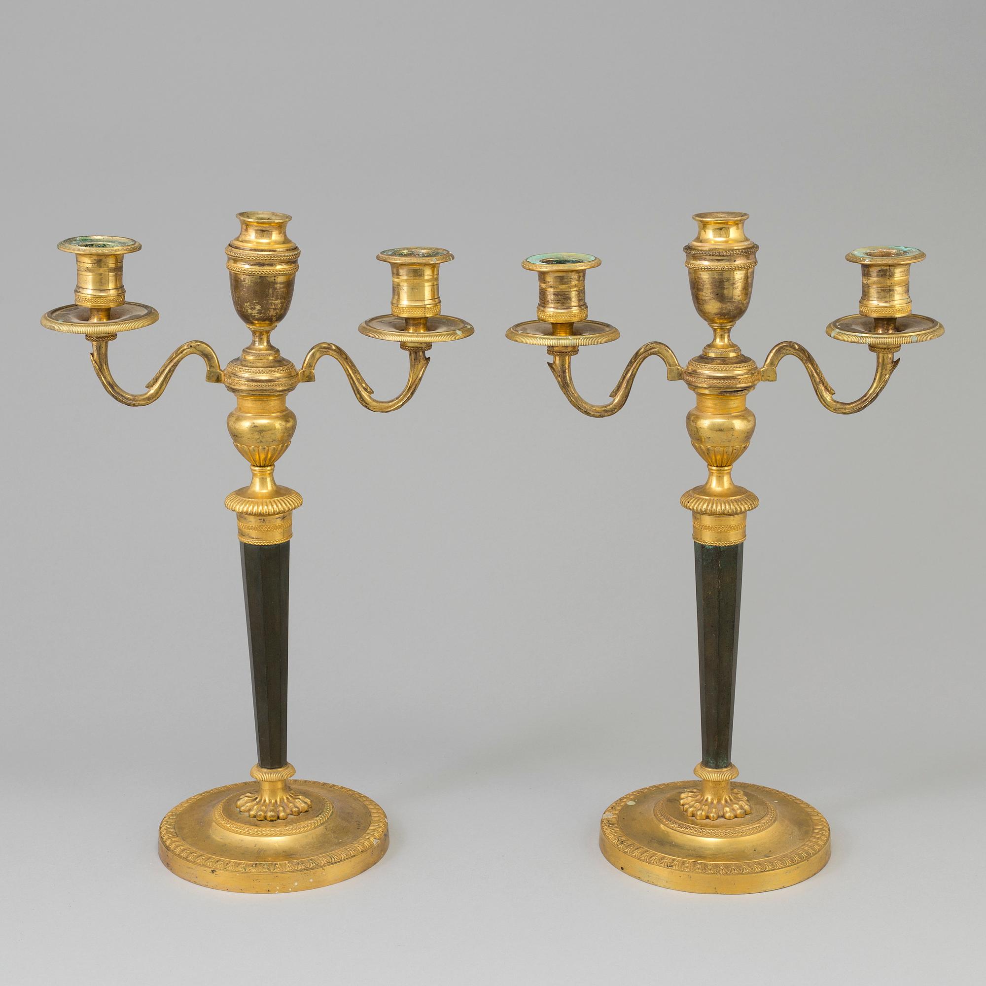 A pair of French Directoire late 18th century ormolu candelabra for three candles.