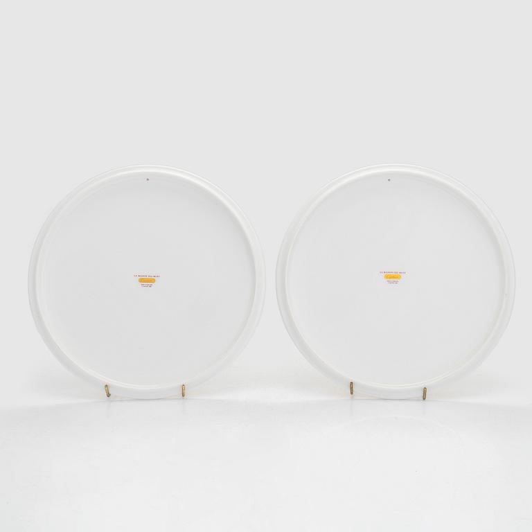 Cartier, two 'La Maison des Must' porcelain cake dishes.