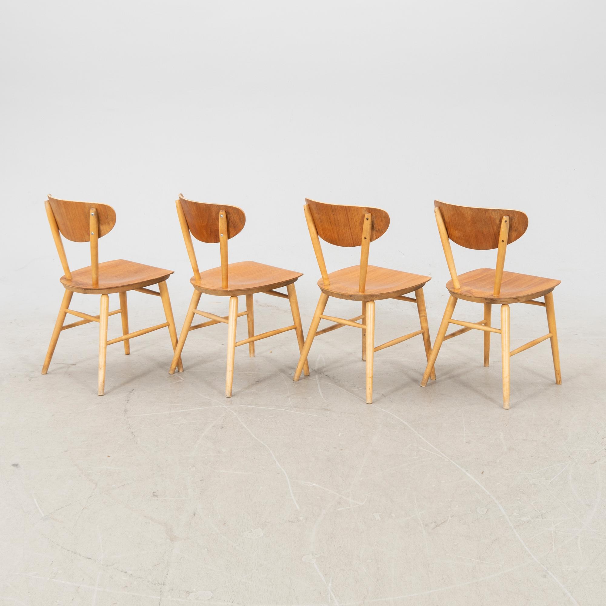 A set of four birch and teak veneered chairs from Bröderna Wigells stolfabrik, Malmbäck mid 20th century.