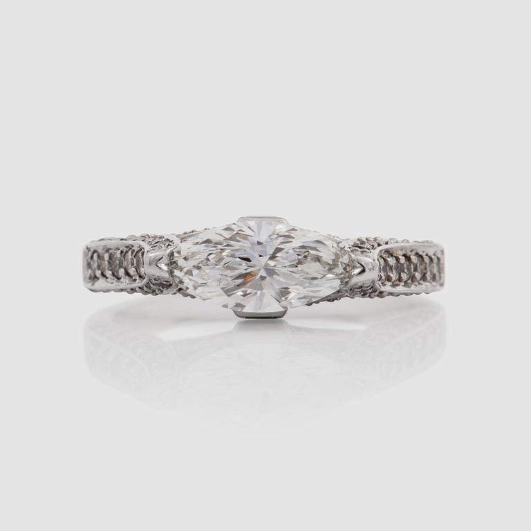 A marquise-cut diamond, circa 0.85 ct, and brilliant-cut and princess-cut diamonds, circa 0.75 ct in total, ring.