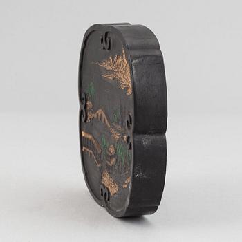 A Chinese ink-cake, with calligraphy and decorated with an ox, 20th Century.