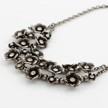 Necklace with matching earrings, white metal in floral design with glass stones.