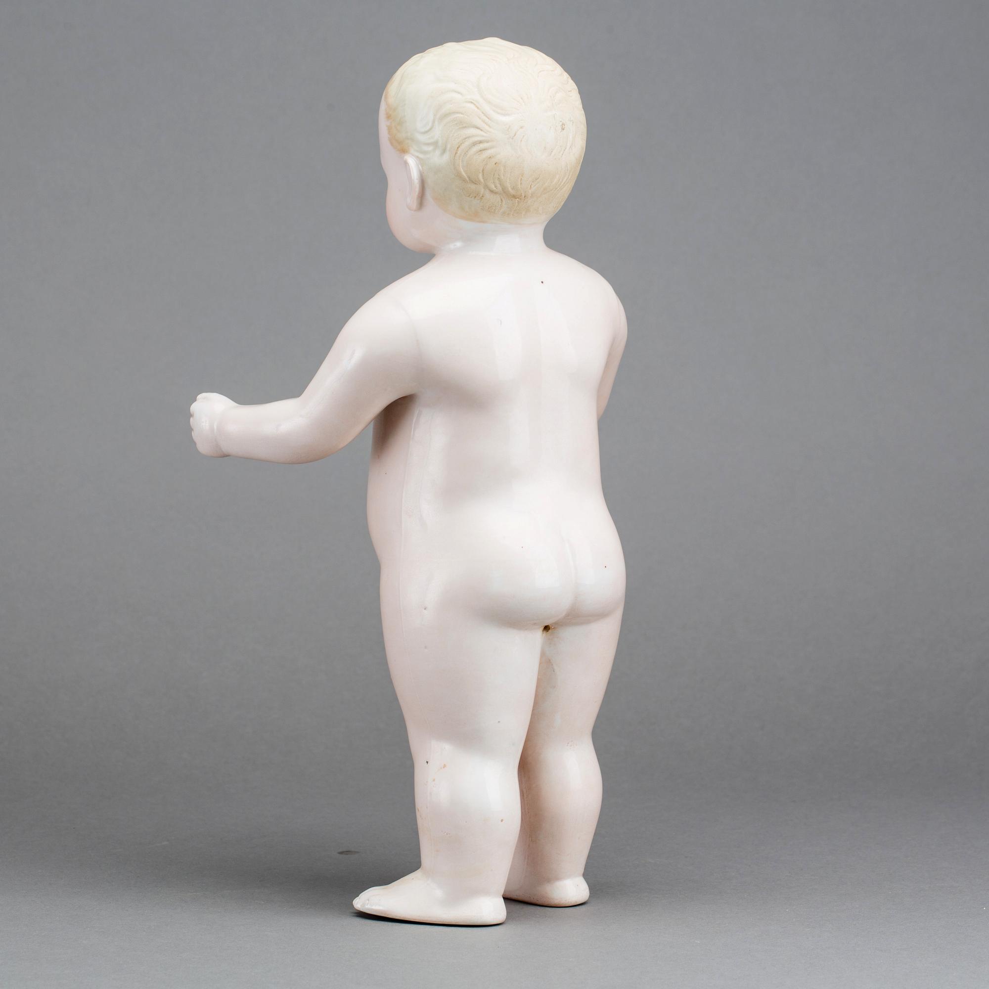 A PORCELAIN "FROZEN CHARLIE" DOLL, from around 1900.