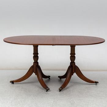 A late 20th century English dining table. One leaf included.