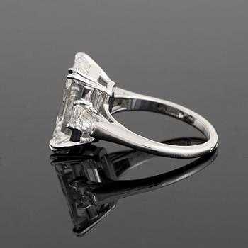 A platinum ring set with an emerald-cut diamond.