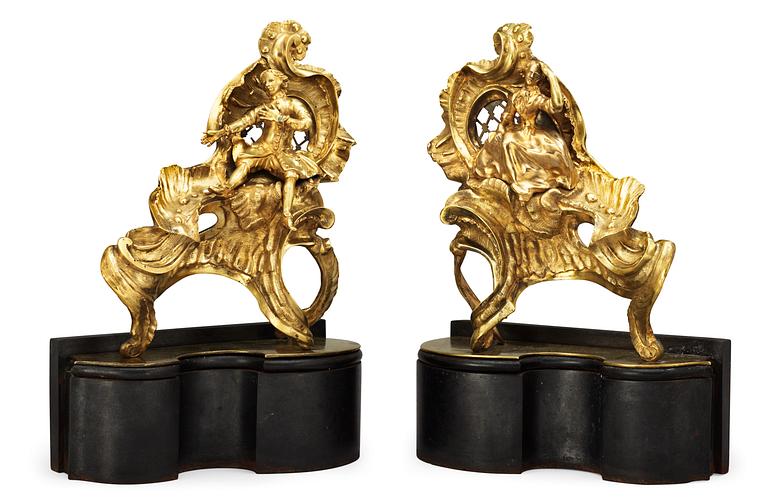 A pair of Louis XV 18th Century bronze chenets, in the manner of Caffieri.