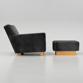 A model 3665 lounge chair with stool by Björn Trägårdh for Firma Svenskt Tenn.