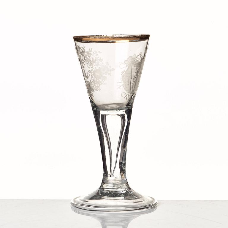 An engraved and gilded armorial wine glass, 18th Century.