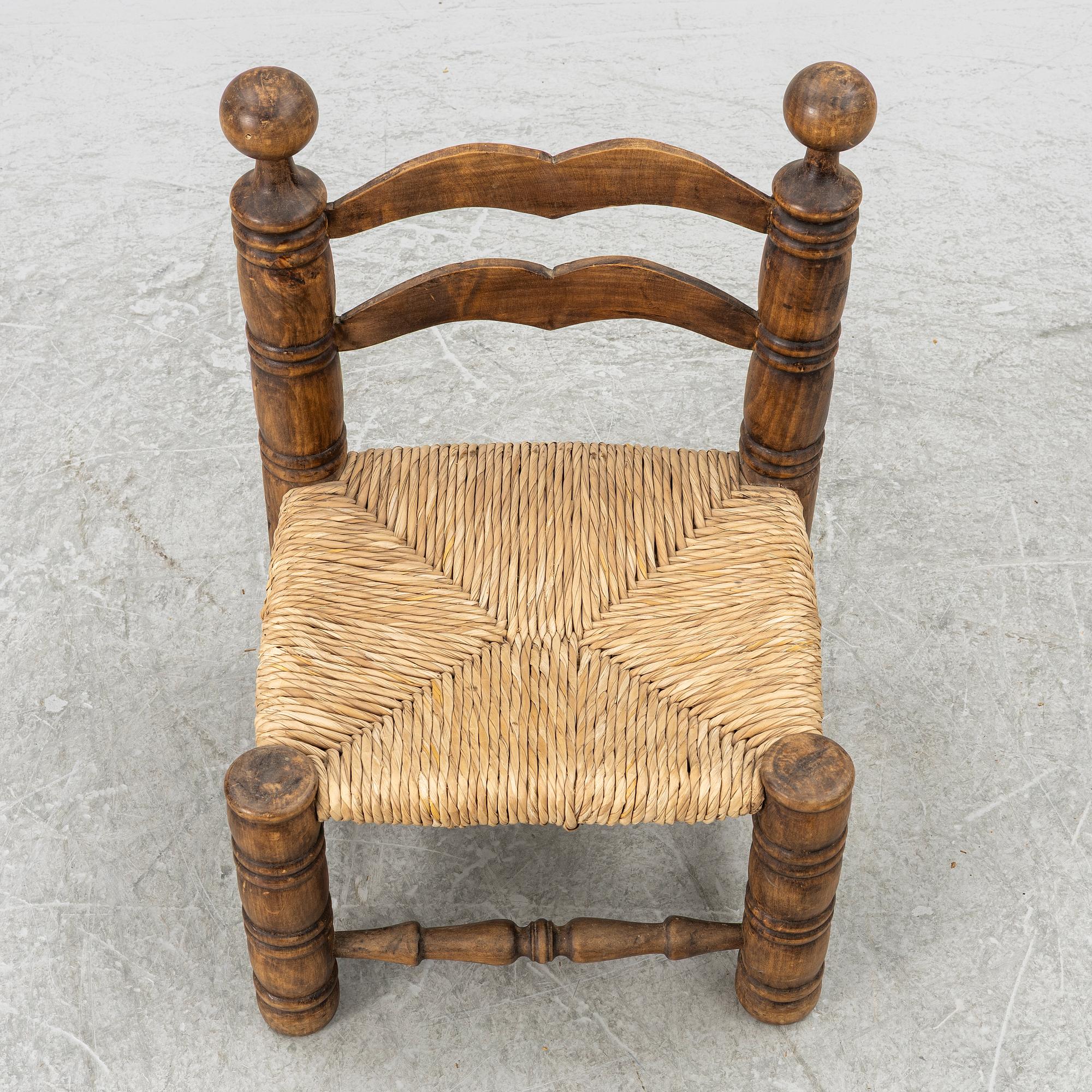 Charles Dudouyt, attributed to, a fireside low chair, mid 20th century.