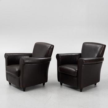 A pair of leather upholstered easy chairs, end of the 20th Century.