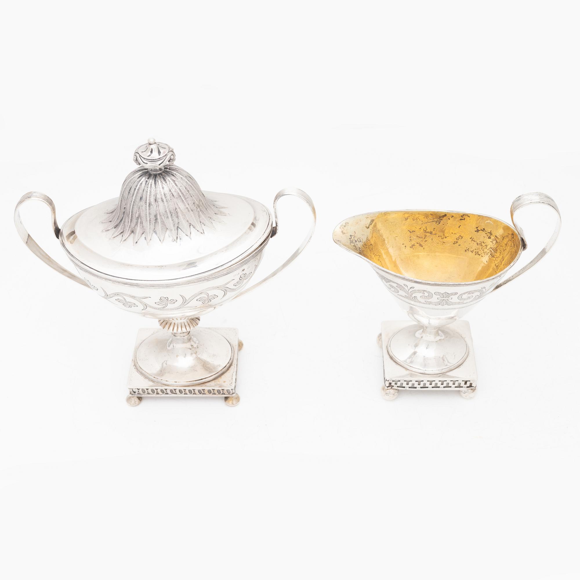 A silver sugarbowl with lid and a creamer, marks of Olof Hellbom, Stockholm, Sweden 1799-1800.