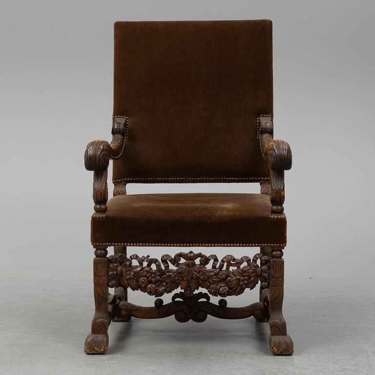 A carved baroque style armchair from around 1900.