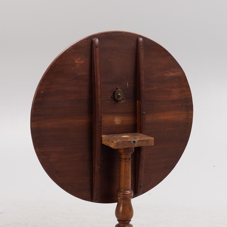 A tilt-top table, 19th century.