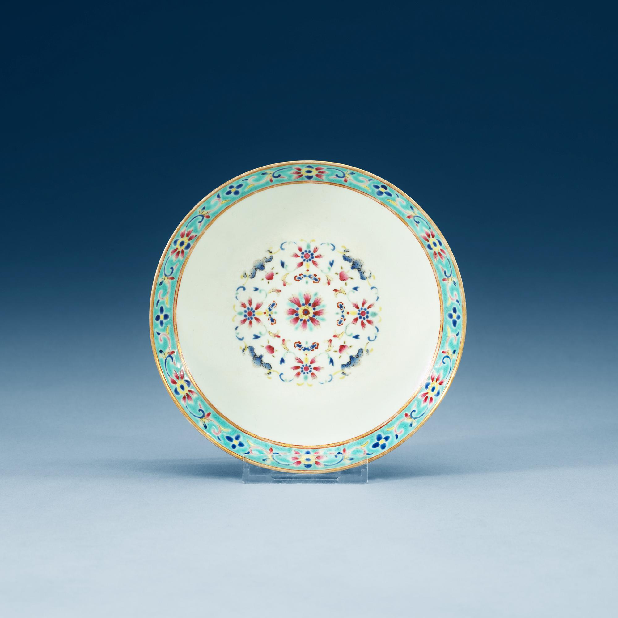 A turkoise ground famille rose dish, Qing dynasty, with Qianlongs seal mark.