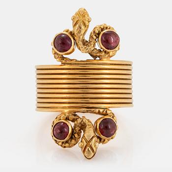 An 18K gold ring set with cabochon-cut garnets design Ilias Lalaounis.