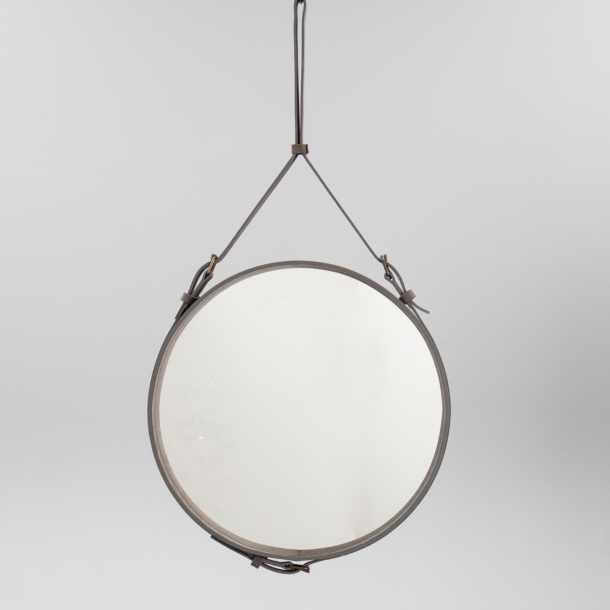 A mirror "Adnet" with leather hanging in original box, designed 1950 by Jacques Adnet for Gubi, Denmark.