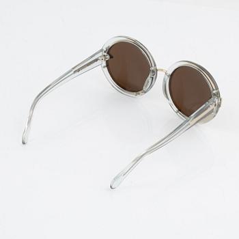 Karen Walker, a pair of "Orbit" sunglasses.