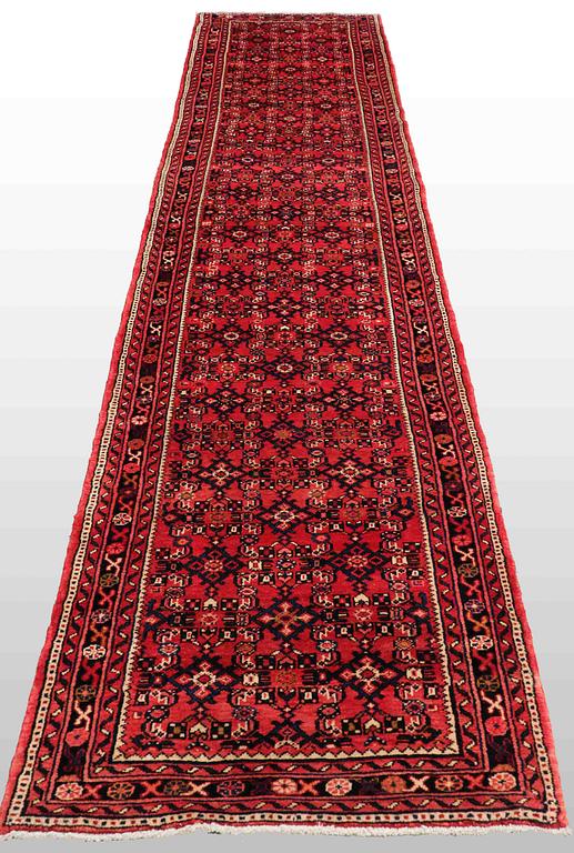 A Hosseinabad carpet, c. 430 x 90 cm.