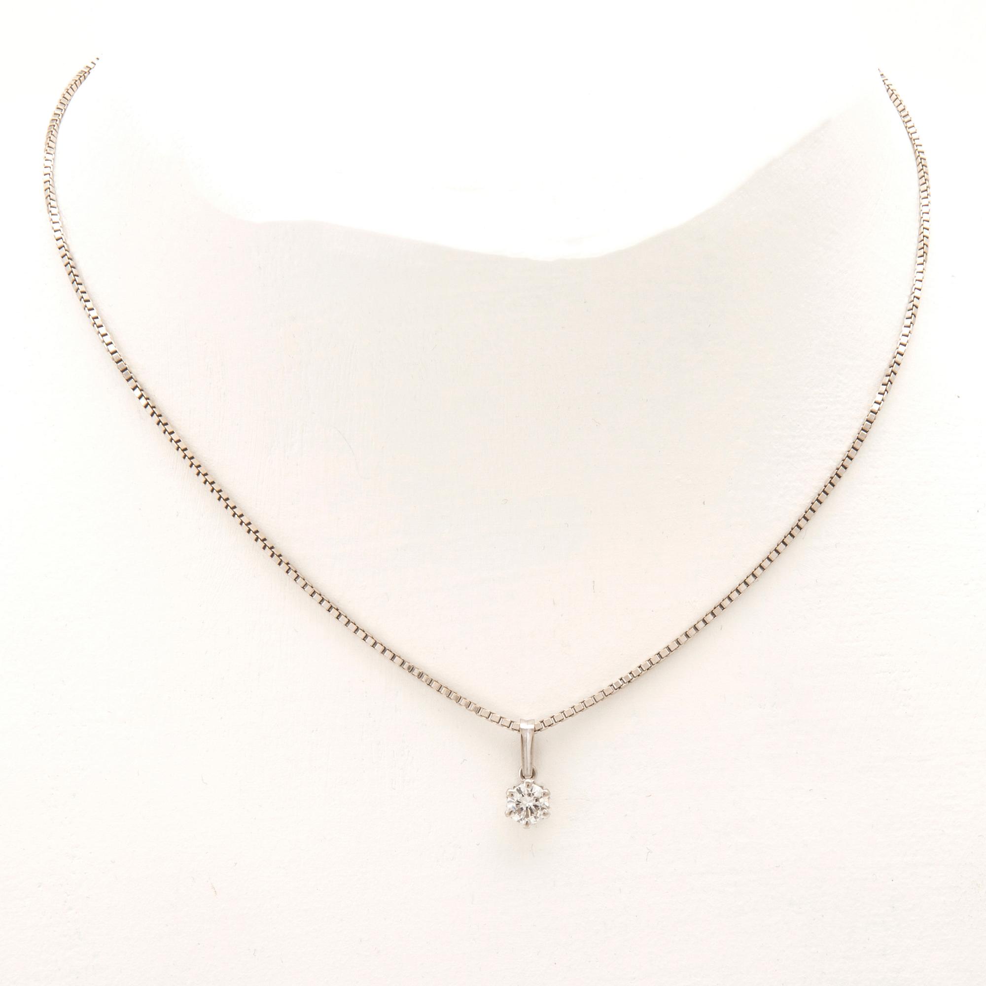 An 18K white gold necklace set with a round brilliant-cut diamond.