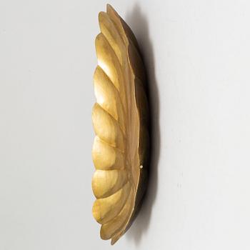 Four brass wall sconces  and one brass plate by Lars Homström, Arvika, second half of the 20th century.