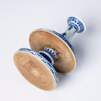 A pair of blue and white pricket candle sticks, with a poem, Qing dynasty with a Qianlong mark and of the period.