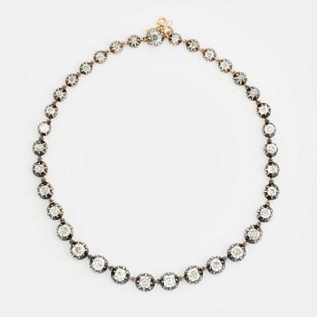 A gold and silver necklace set with old-cut diamonds.