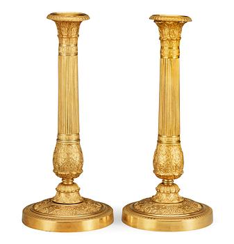 623. A pair of French Empire early 19th century candlesticks.