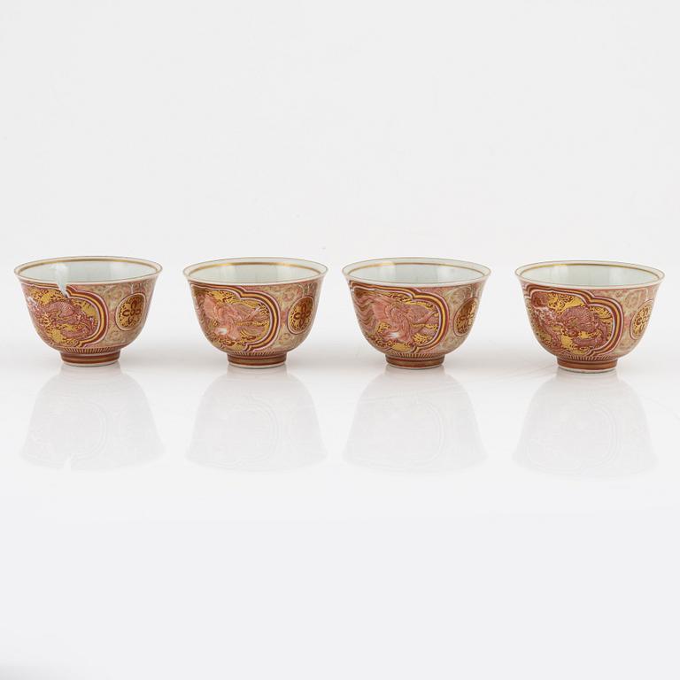 A set of four iron red and gilded wine cups, Japan, early 20th Century.