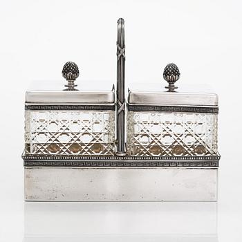 K. Fabergé, a pair of cut-glass toilette boxes in silver stand, Imperial Warrant mark, Moscow 1896.