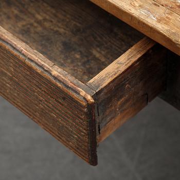 A 19th Century table with drawers.