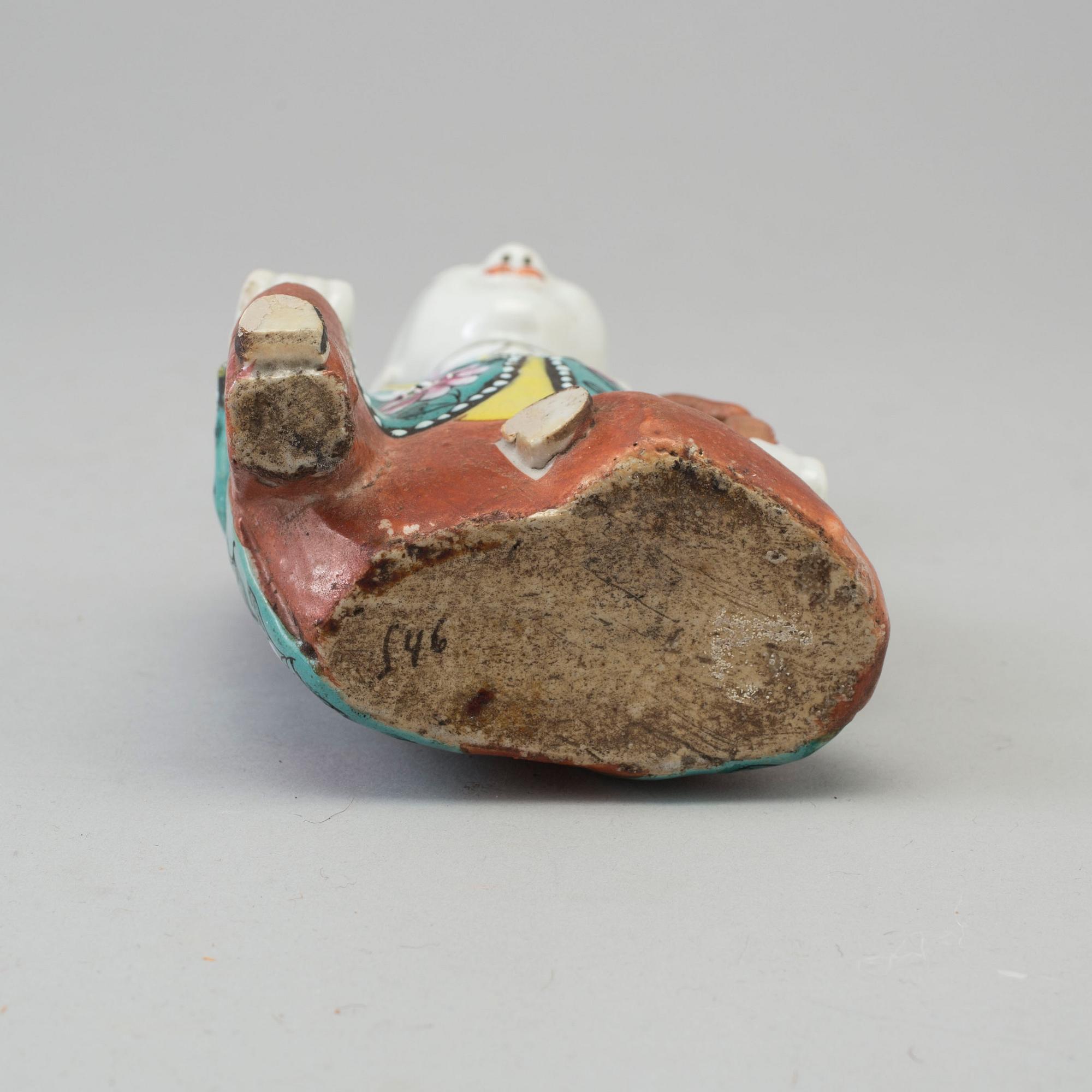 A porcelain figure of a laughing boy, Qing dynasty, 19th Century.