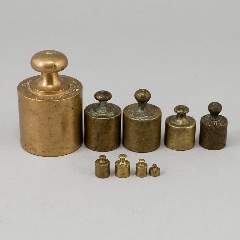 A 20th century cast iron balance with brass and iron weights, partly Skultuna, Sweden.
