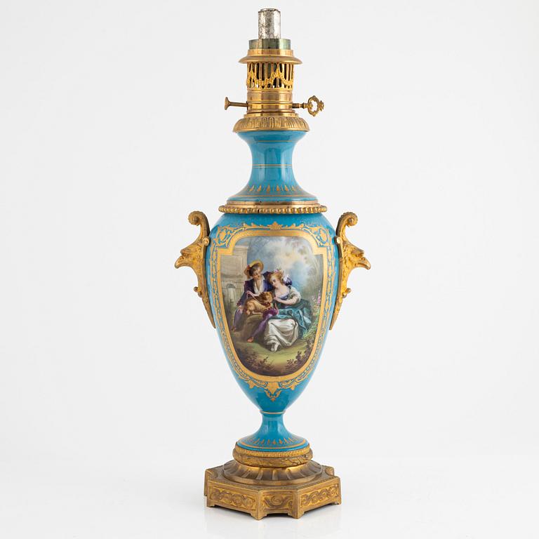 A gilt-brass and porcelaine Louis XVI-style kerosene lamp, later part 19th century.