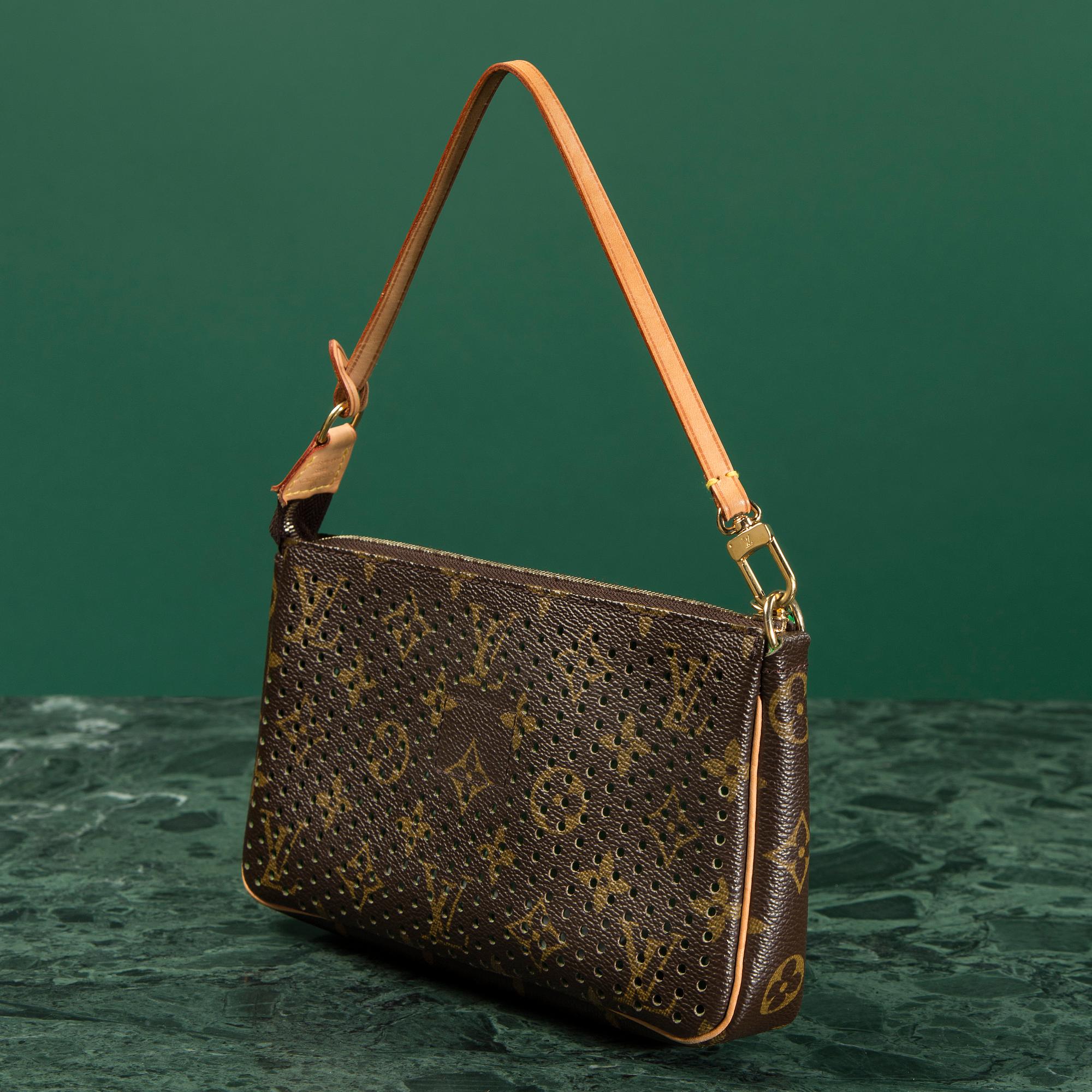 A CLUTCH by Louis Vuitton.